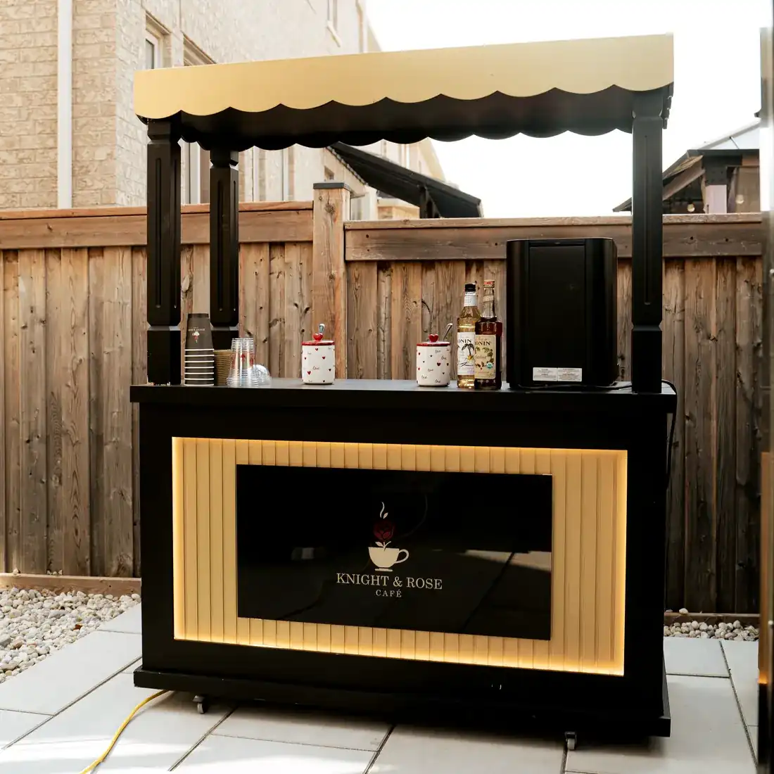 The Knight & Rose mobile café cart in black and gold.